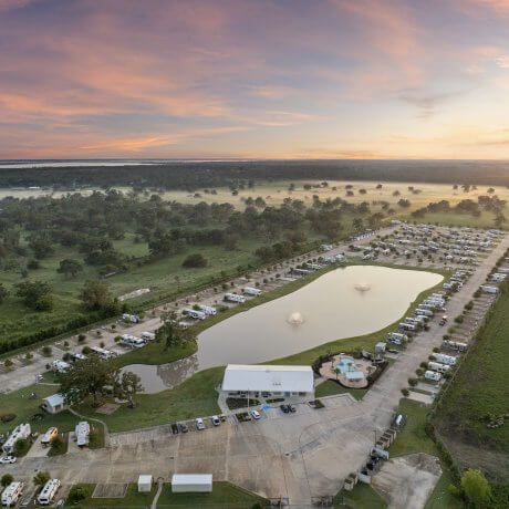 High-altitude aerial view of Brazoria Lakes RV Resort and surrounding farmland in Brazoria, Texas during twilight