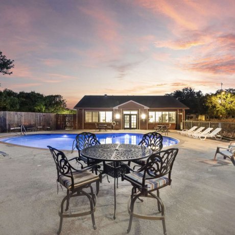 Twilight poolside seating at Allstar RV Resort in Southwest Houston
