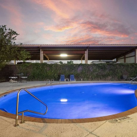 Lighted pool at Allstar RV Resort in Houston TX illuminated at night