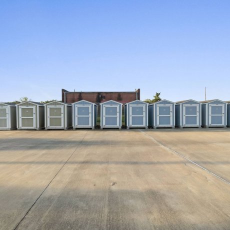 Row of on-site storage sheds at Highway 6 RV Resort with paved access and clear driveways — secure storage for RV gear near Houston, TX