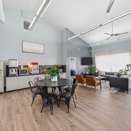 Clubhouse community lounge with coffee bar dining area and lake view at Mont Belvieu RV Resort near Houston Texas