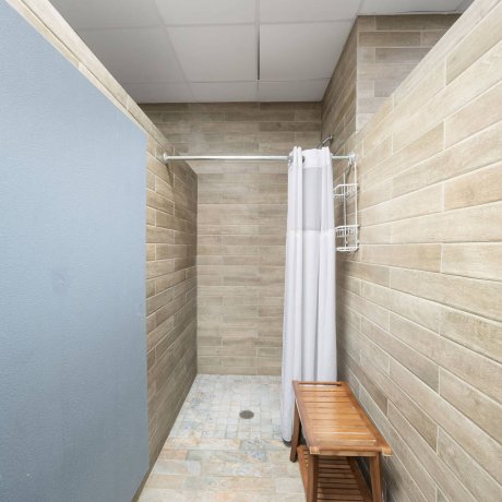 Private shower room with modern tile design at Westlake RV Resort in Houston, TX