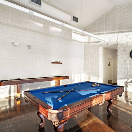Highway 6 RV Resort billiards room with blue-felt pool table and shuffleboard — Houston, TX guest amenities