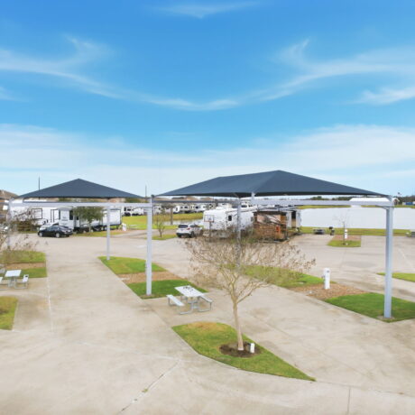 Covered canopy RV sites with picnic tables and lake views at Mont Belvieu RV Resort near Houston Texas