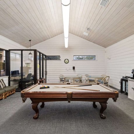 Allstar RV Resort recreation room with pool table, lounge seating, and game tables in Houston, TX