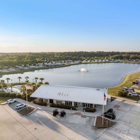 Aerial view of Eastlake RV Resort in Houston, TX showing the clubhouse, lake, pool, and RV sites near 77044