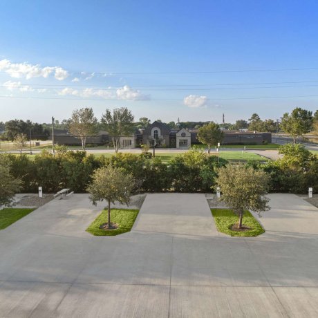 Spacious concrete RV pads with full hookups and tree-shaded areas at Fallbrook RV Resort in North Houston, TX.