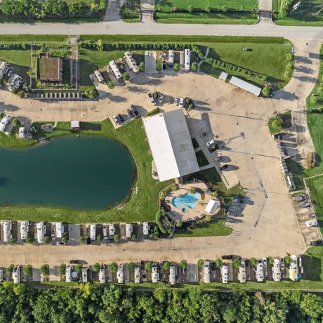 Aerial view of Highway 6 RV Resort showing lakeside full-hookup RV sites, clubhouse, and pool — Houston, TX monthly RV stays