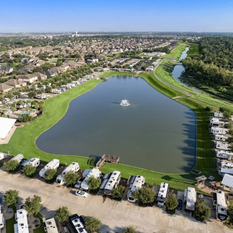 Aerial view of Westlake RV Resort lakefront RV sites and fountain in Houston, Texas