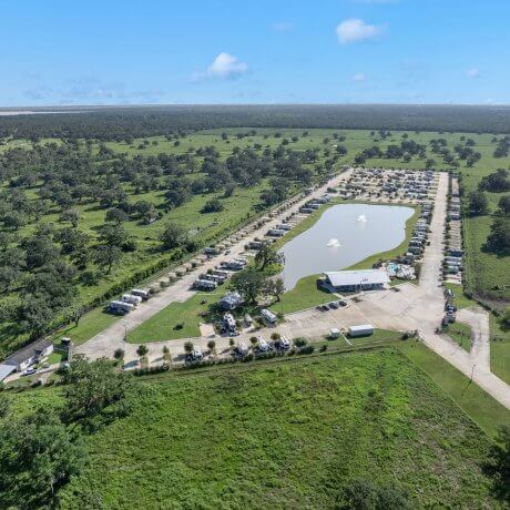 High-altitude aerial view of Brazoria Lakes RV Resort and surrounding farmland in Brazoria, Texas