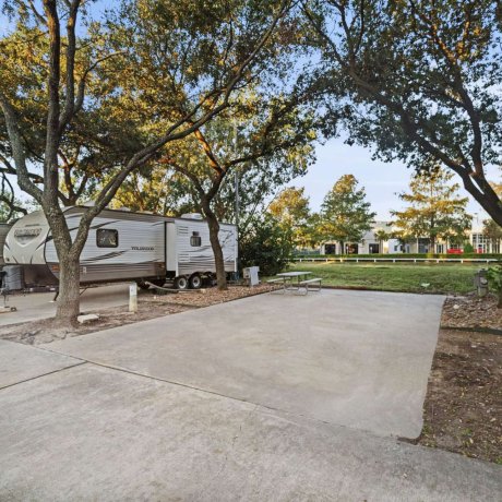Shaded RV site with picnic table at Allstar RV Resort in Houston, TX