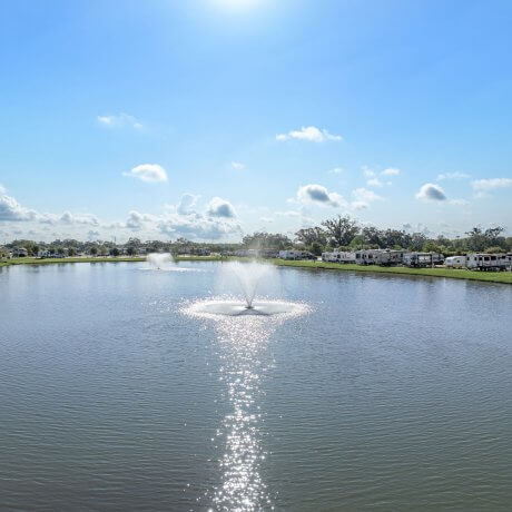 Two fountains in the lake at Brazoria Lakes RV Resort in Brazoria, Texas