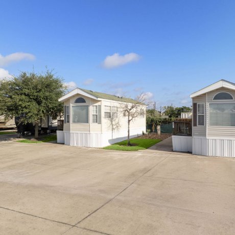 Park model rentals at Westlake RV Resort in Houston, TX with concrete pads and green lawns