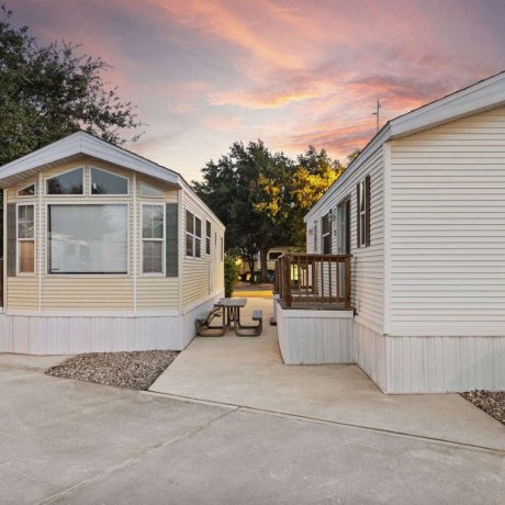 Two park model rentals with decks at Allstar RV Resort in Houston, TX