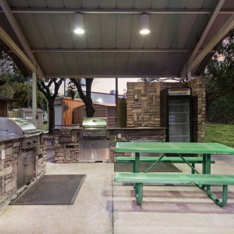 Outdoor BBQ grill and covered picnic area at Allstar RV Resort in Houston, TX