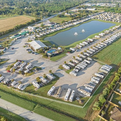 Aerial shot of Mont Belvieu RV Resort showing pool, lake and waterfront RV sites — family-friendly amenities in Baytown, TX