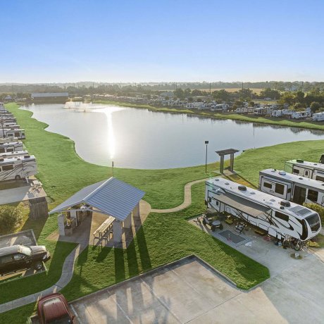 Scenic lake and fountain at Mont Belvieu RV Resort — waterfront sites and shaded pavilion for family getaways, Baytown TX