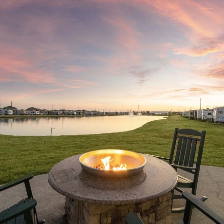 Twilight firepit and pond at Mont Belvieu RV Resort — comfortable monthly RV sites near Baytown refineries