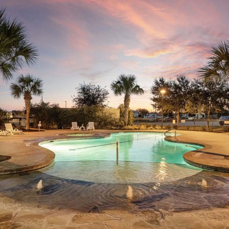Twilight pool and splash area at Mont Belvieu RV Resort — relaxing evenings after shifts, near Baytown refineries