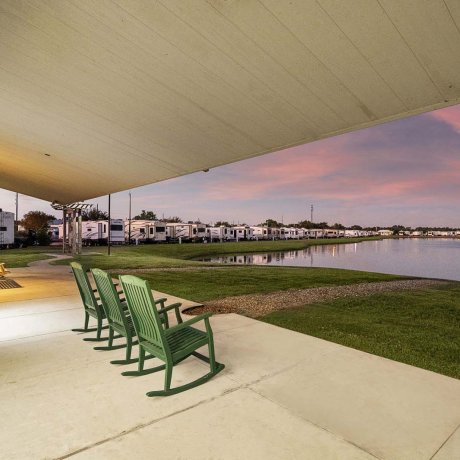 Porch rockers overlooking the pond at Mont Belvieu RV Resort — monthly RV sites near Baytown refineries on FM-565