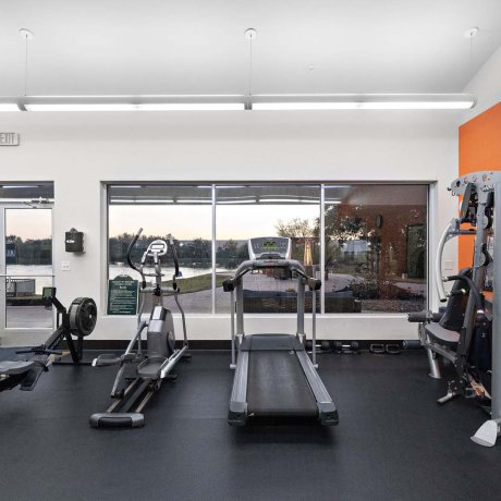 Fitness room with treadmill, elliptical, rowing machine, and weight machine at Southlake RV Resort in Houston, TX