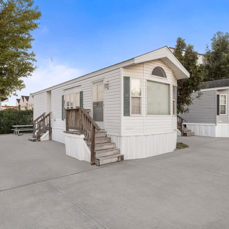 Park model rentals with porch steps and picnic area at Southlake RV Resort in Houston, TX