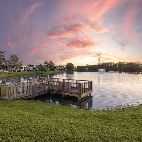 Lakeside wooden fishing dock at Southlake RV Resort in Houston, TX during sunset