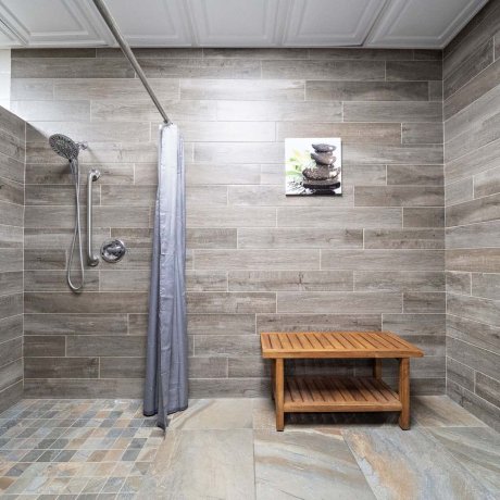 ADA-accessible tiled shower with bench and safety rails at Southlake RV Resort