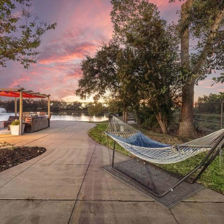 Hammock and patio lounge by the lake at sunset at Southlake RV Resort in Houston, TX
